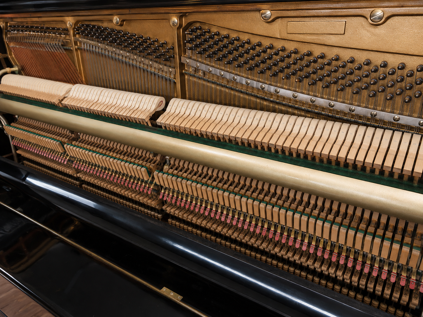 Internal piano action and components inspected before deciding whether an old piano is worth repairing