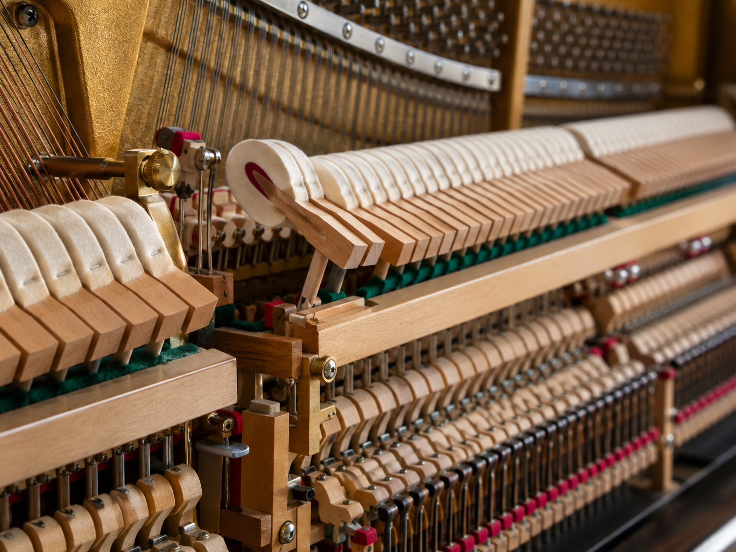 technician inspecting the piano action and key movement