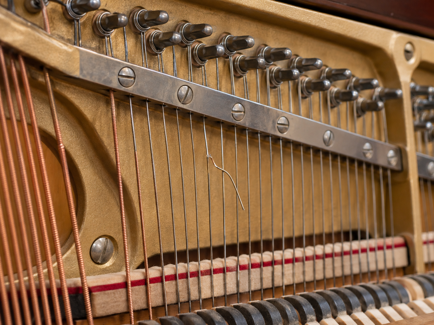 upright piano opened for inspection of the strings and internal condition